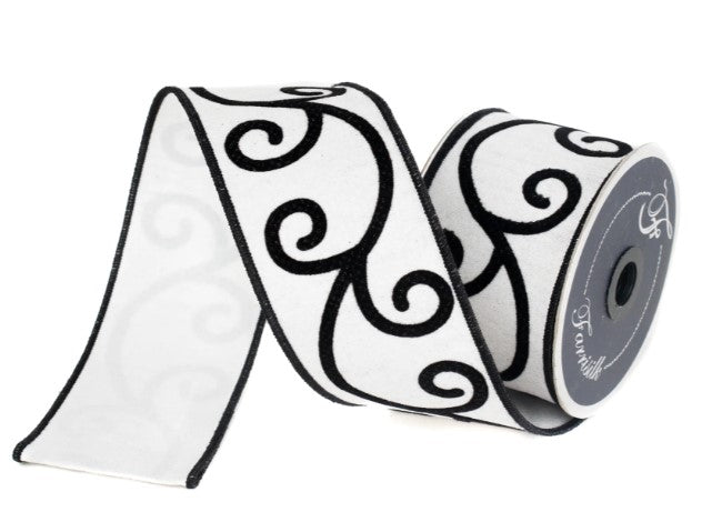 A roll of black and white decorative ribbon with a repeating black swirl pattern.