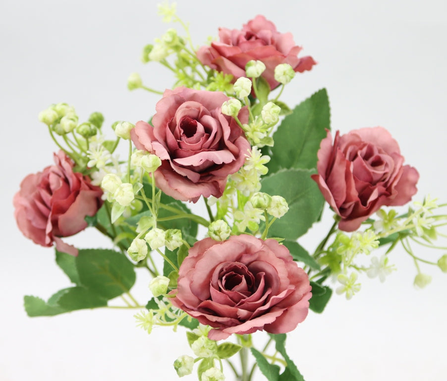 a vase filled with pink flowers on top of a table