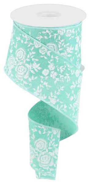 a roll of ribbon with white flowers on it