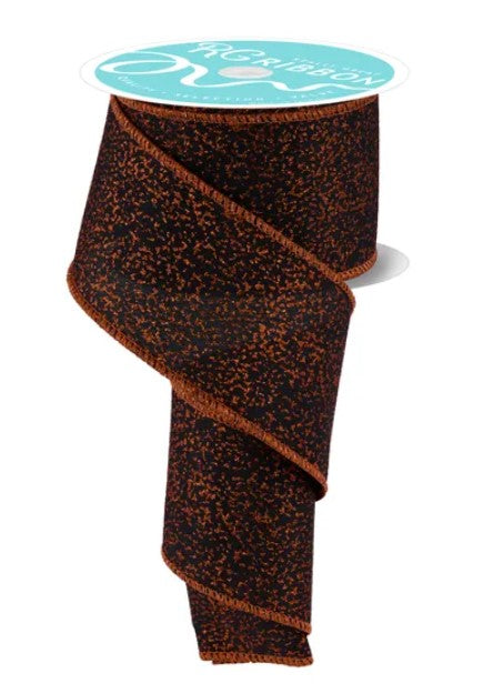 a roll of brown and black sparkly ribbon with a turquoise label on top.