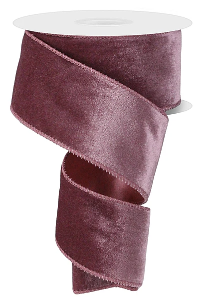 A roll of maroon velvet ribbon with a shiny, smooth texture.