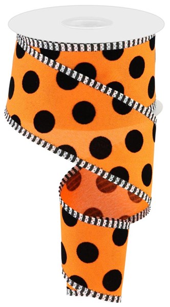 a roll of orange and black polka dot ribbon