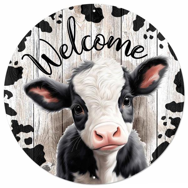 a picture of a black and white cow with the words welcome