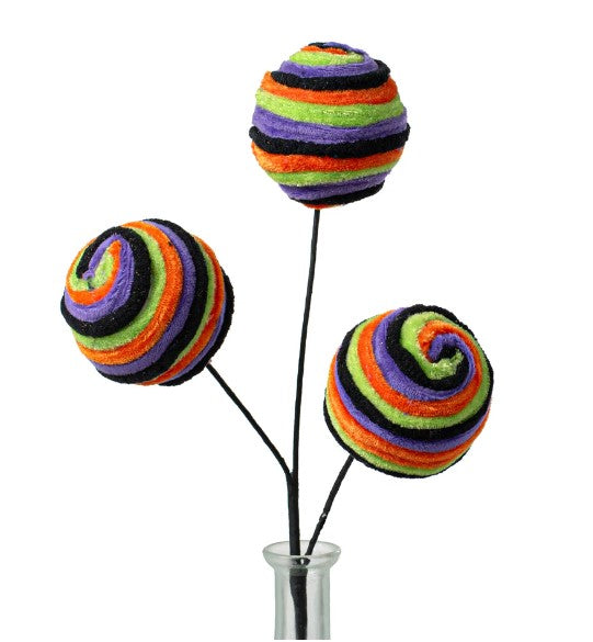 a vase filled with three colorful balls of yarn