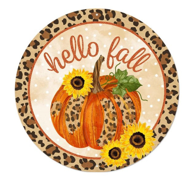 A round, leopard print plate with a pumpkin and sunflowers, along with the text "Hello fall" written on it.