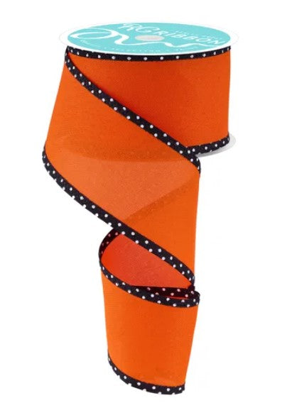 An orange and black polka dot ribbon is shown against a white background.