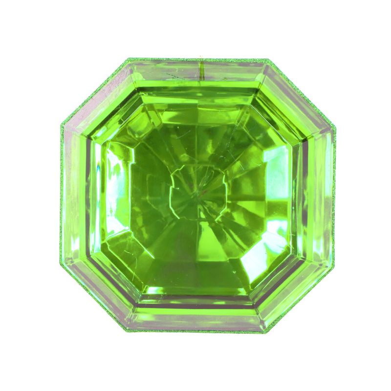 a close up of a green diamond on a white background