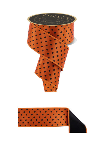 a roll of orange and black polka dot ribbon