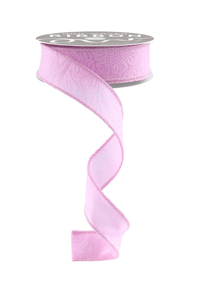 a roll of pink satin ribbon on a white background