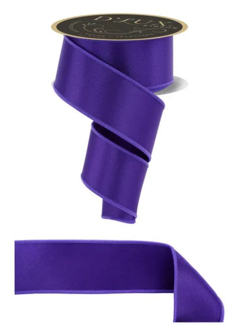 a purple ribbon with a gold label.