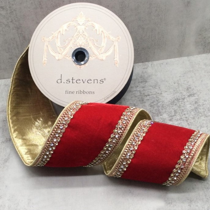A roll of red velvet ribbon with gold trim and rhinestones, along with a white label that reads "d.stevens fine ribbons".