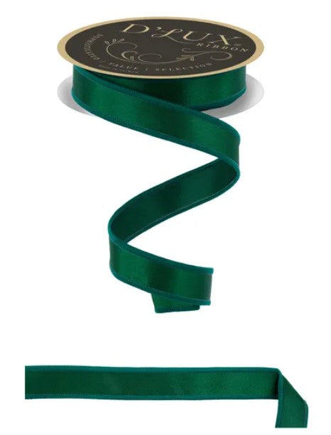 A roll of dark green satin ribbon with a gold label, and a long, curled piece of the same ribbon.