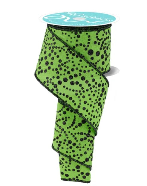 A roll of green and black polka dot ribbon with a turquoise label.