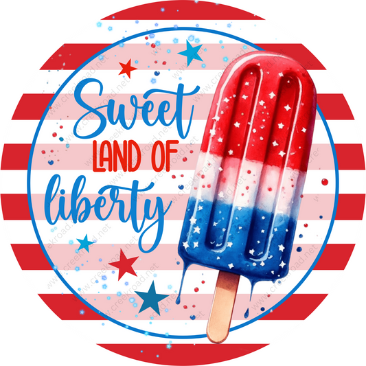 a red, white, and blue popsicle with the words sweet land of liberty