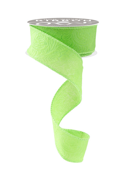 A roll of green floral patterned ribbon is shown against a white background.