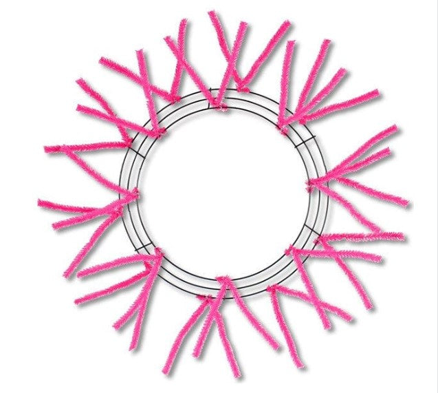a circular frame made of pink pipe cleaners, with the pipe cleaners arranged in a circular pattern around the frame.