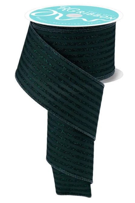 a spool of dark green, striped ribbon with a white label on top.