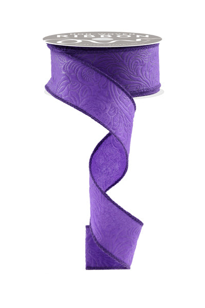 a roll of purple satin ribbon on a white background