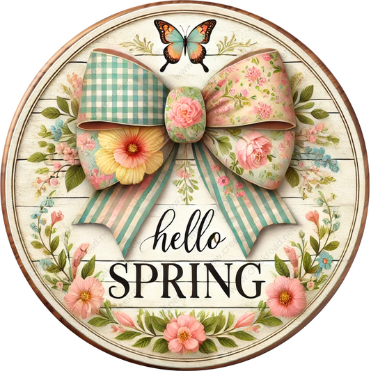 a sign with a bow and flowers on it