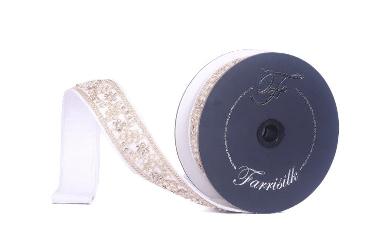 A spool of black and white fabric ribbon with a gold floral pattern, labeled "Farrissil" on the spool.