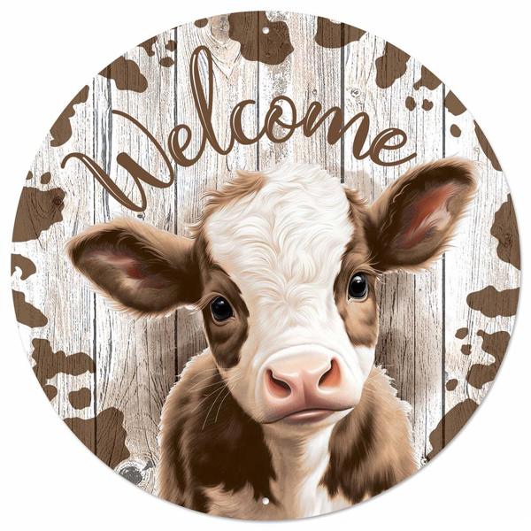 a brown and white cow with the word welcome on it's face