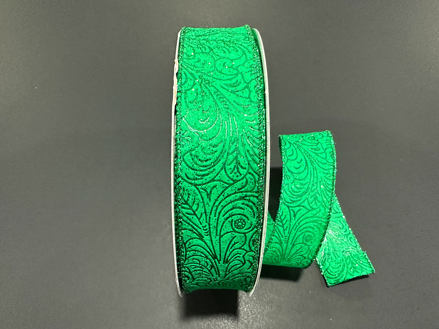 a pair of green ribbon sitting on top of a table