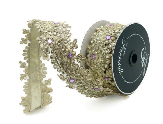 a spool of decorative lace ribbon with a floral pattern and small purple accents.