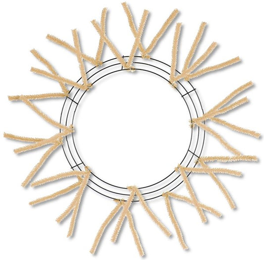 a circular frame made of beige wire or straw, with numerous thin, straight branches or sticks attached to it, creating a decorative and textured appearance.