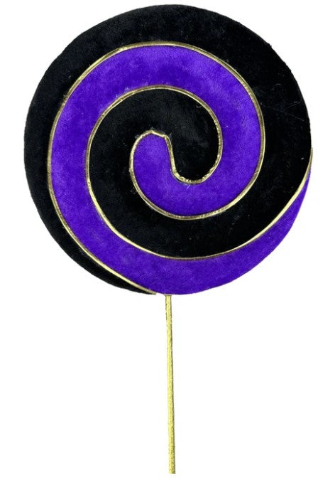 a purple and black lollipop on a stick