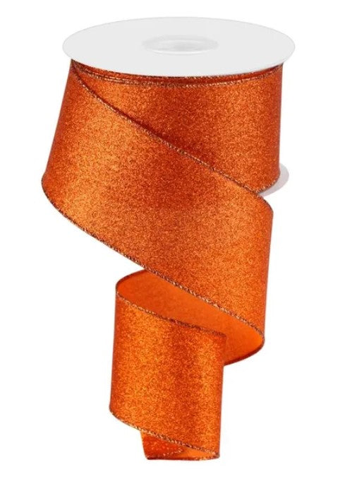 a roll of orange glittery ribbon with a white top.