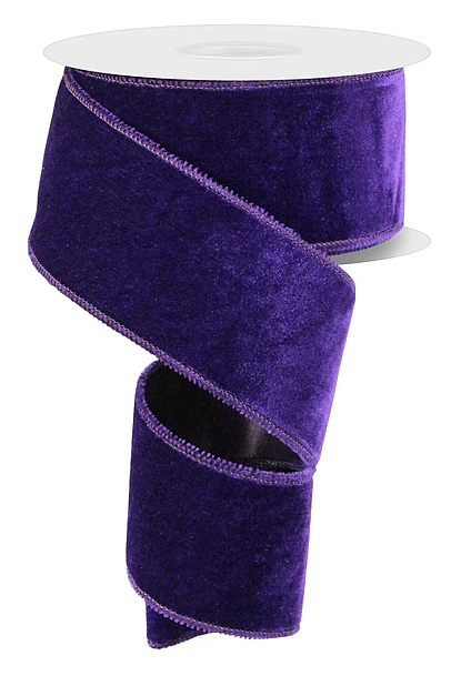 A roll of purple velvet ribbon with a white backing.