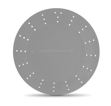 A gray circular object with small holes arranged in a circular pattern.