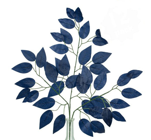 a vase filled with blue leaves on top of a table