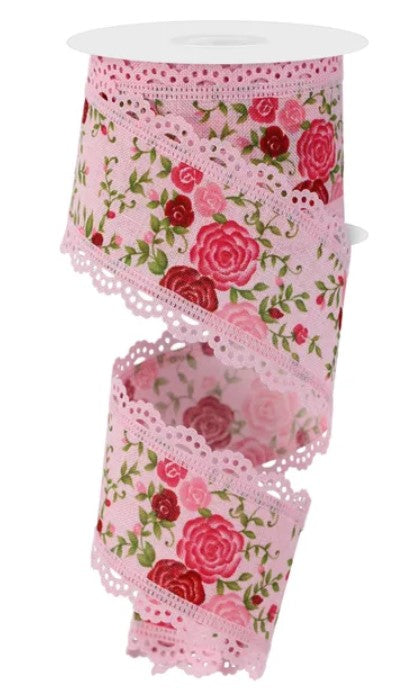 A pink floral fabric with a scalloped edge and lace trim.