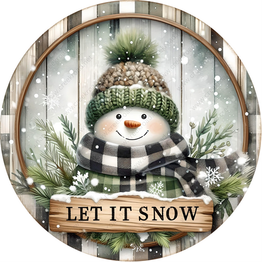 a picture of a snowman with a sign that says let it snow