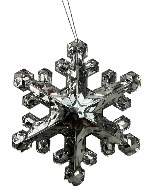 A sparkling crystal snowflake ornament is suspended against a black background.
