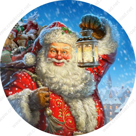 A smiling, bearded Santa Claus holding a lantern and carrying a sack of presents, set against a snowy winter landscape with a church in the background.