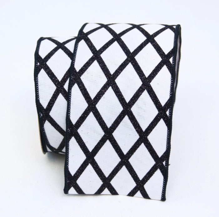 a black and white diamond pattern on a fabric, with the diamonds arranged in a diagonal grid.