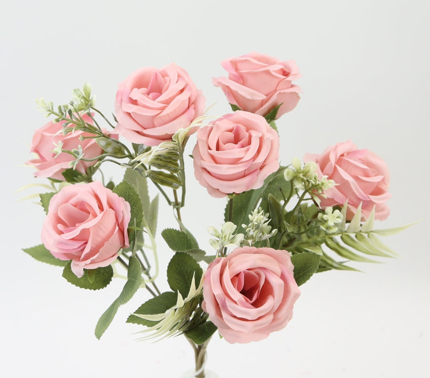 A bouquet of pink roses with green leaves, arranged in a vase.
