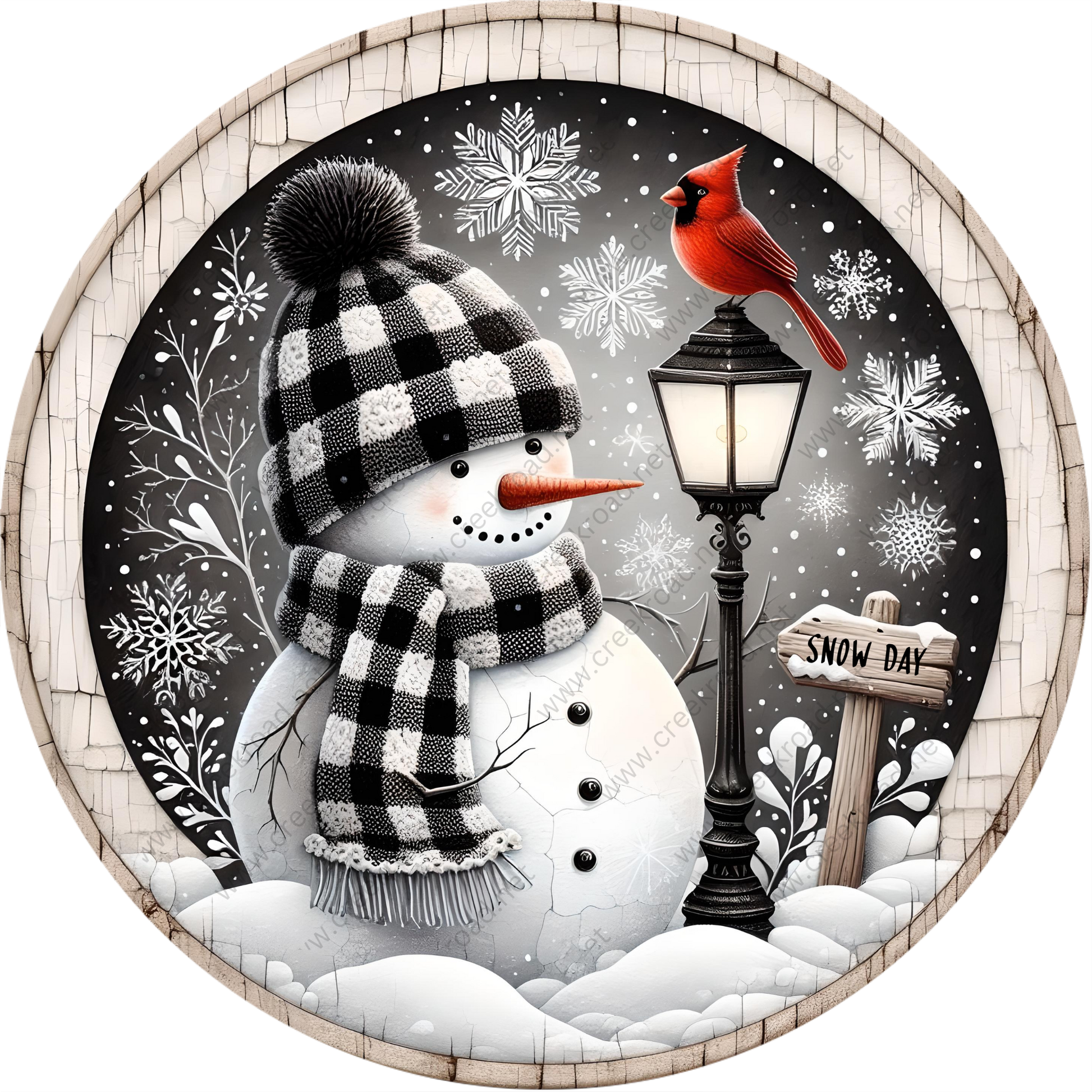 A snowman wearing a black and white checkered hat and scarf stands next to a black lamppost with a red cardinal perched on top. The snowman is surrounded by snowflakes and a snow-covered landscape, with a "Snow Day" sign visible in the background.