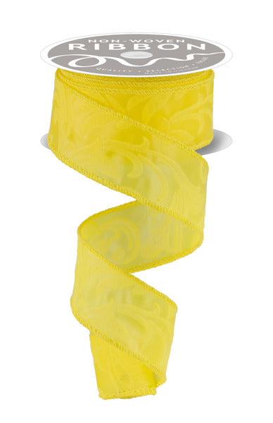 a yellow ribbon with a floral pattern, hanging from a spool of ribbon.