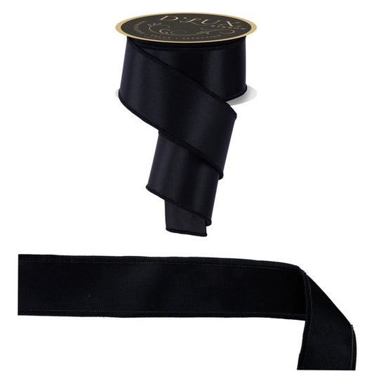 a black ribbon with a gold label, and a black ribbon lying on the ground.