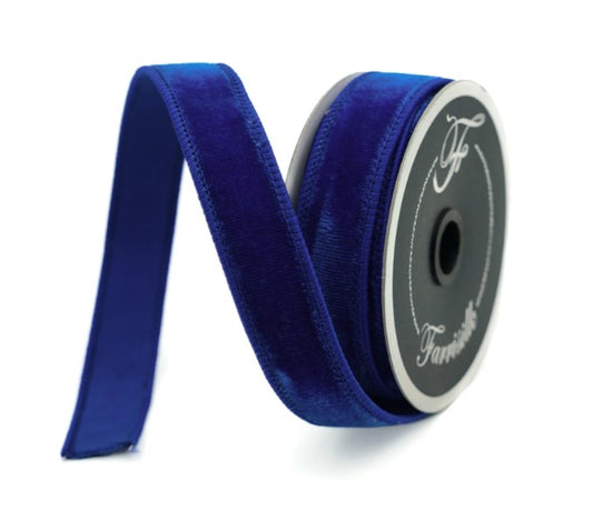 A roll of blue velvet ribbon is shown against a white background.