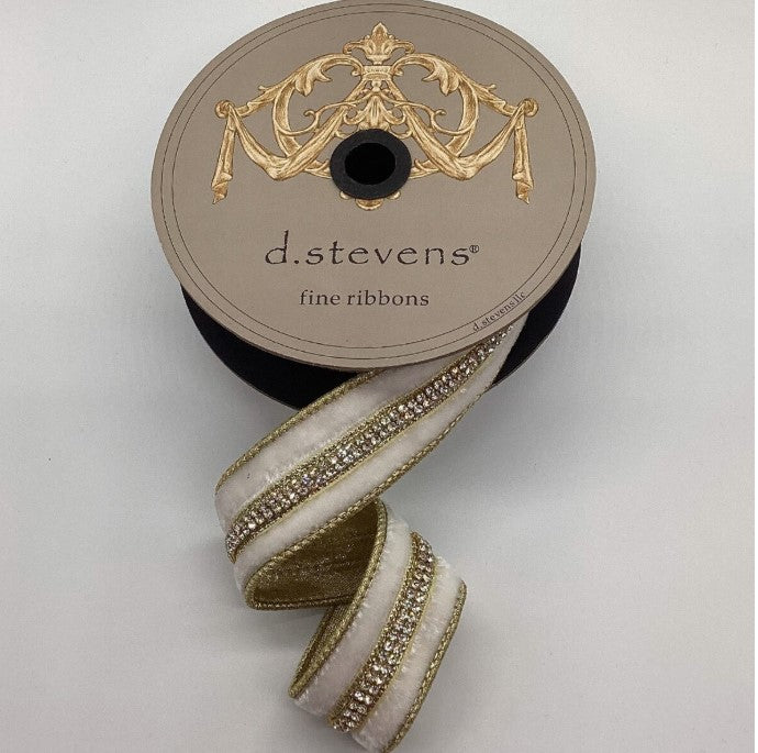 A spool of ribbon with a decorative design on the top and a white and gold ribbon with rhinestones on the bottom.