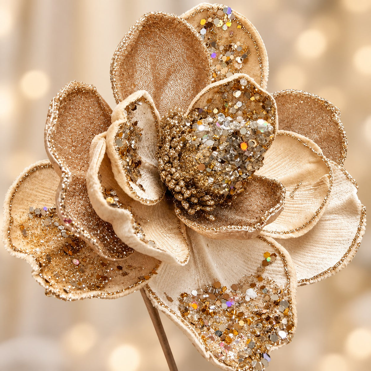 A close-up of a decorative flower with gold and glittery petals, creating a sparkling and elegant appearance.