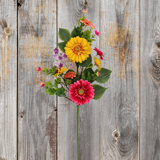 A vibrant bouquet of colorful flowers, including yellow and red blooms, is displayed against a weathered wooden background.
