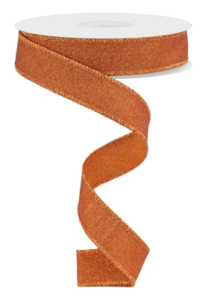 a roll of orange glitter ribbon on a white background