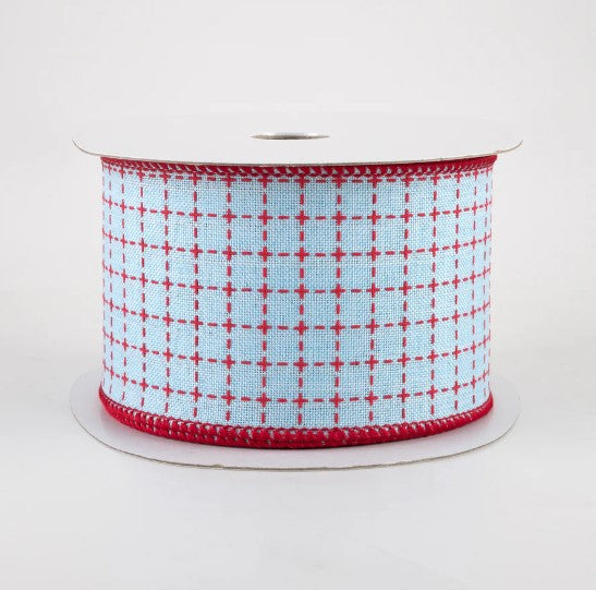 a spool of red and white ribbon on a white background