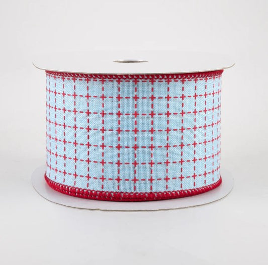 a spool of red and white ribbon on a white background