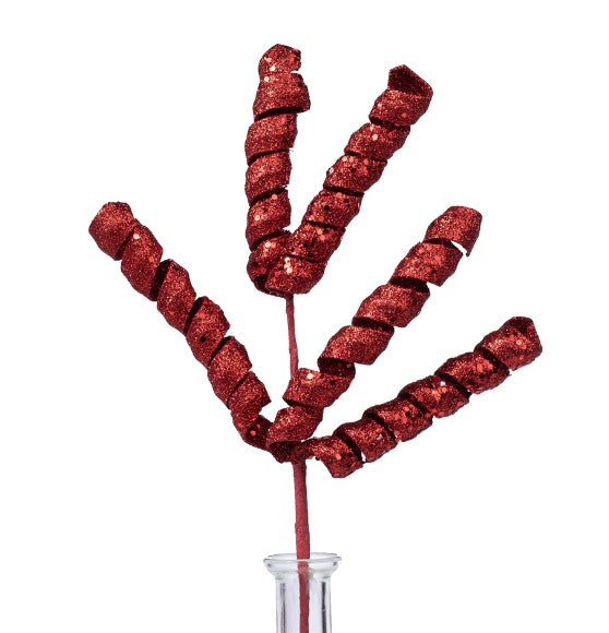 a glass vase filled with candy sticks on top of a table